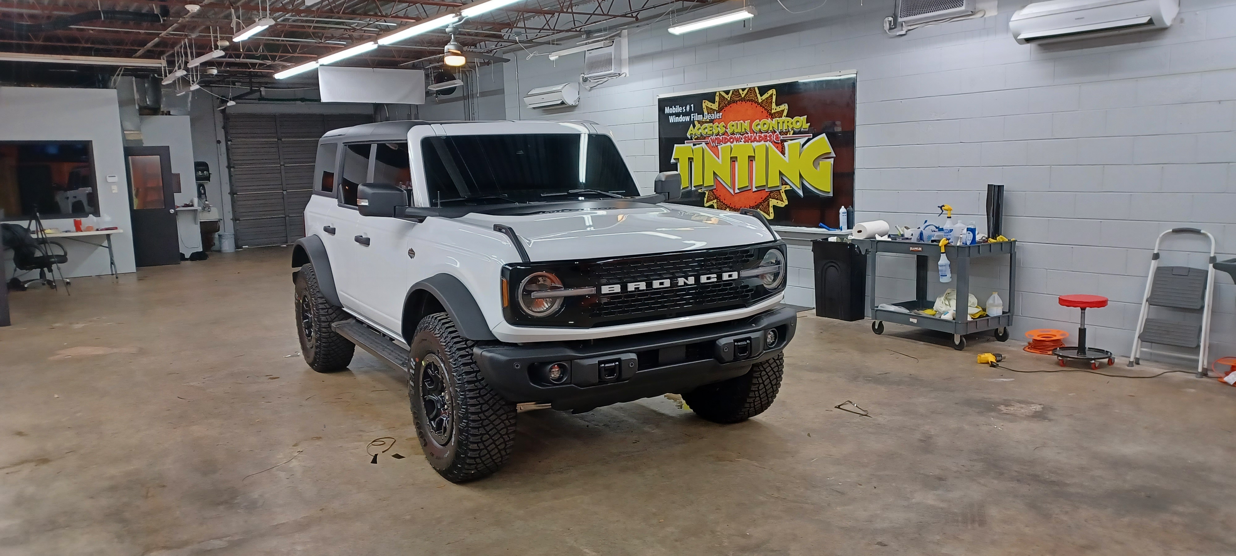 Professional auto window tint installation on sedan